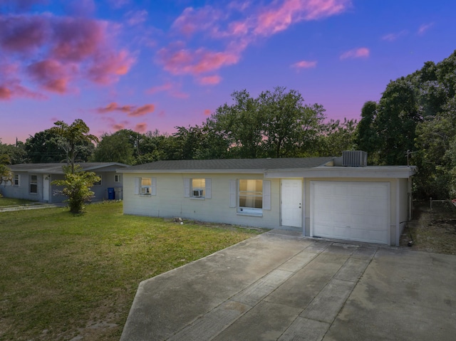 single story home featuring a yard and a garage