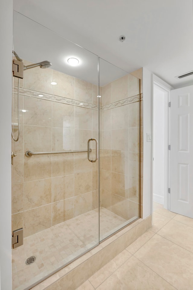 bathroom featuring an enclosed shower and tile floors