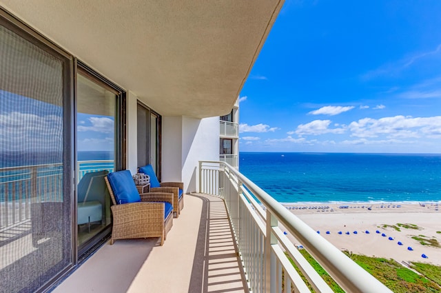 balcony with a beach view and a water view