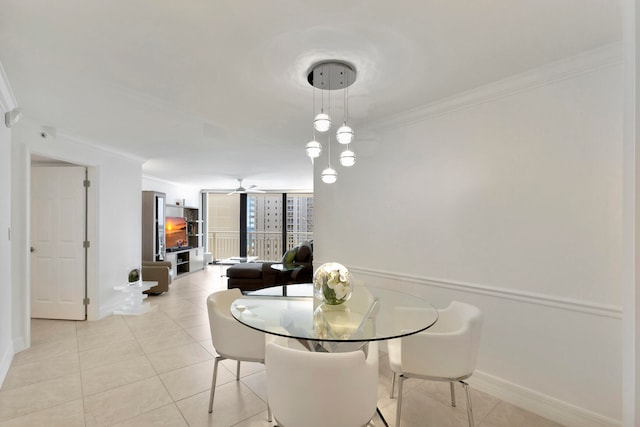 dining room with ceiling fan, light tile flooring, and ornamental molding