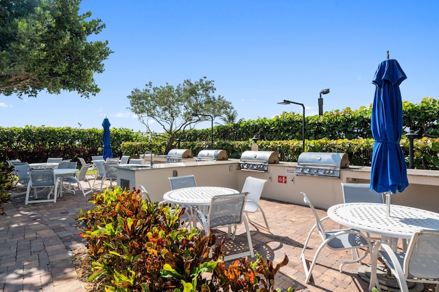 view of terrace with area for grilling and an outdoor kitchen