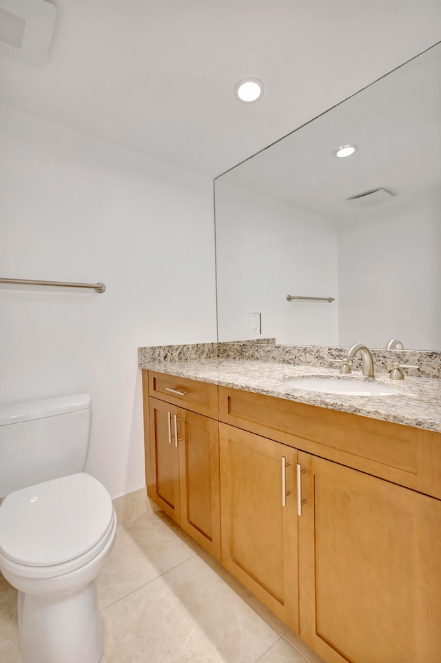 bathroom featuring large vanity, tile floors, and toilet