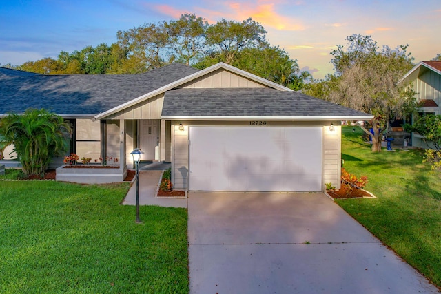 single story home with a yard and a garage