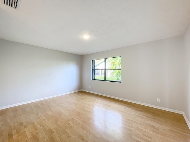 empty room featuring ceiling fan and light hardwood / wood-style flooring