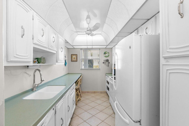 kitchen with white cabinetry, white fridge, ceiling fan, and sink