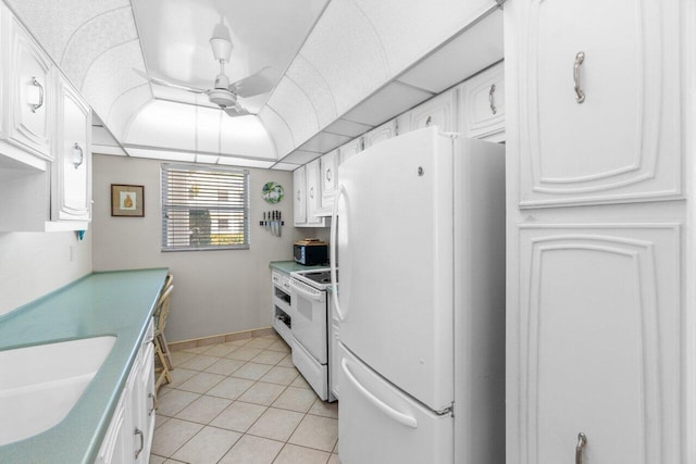 kitchen with ceiling fan, white appliances, sink, light tile floors, and white cabinets