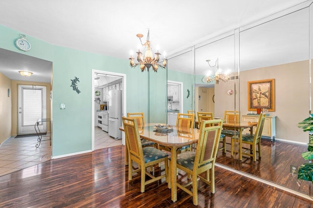 dining area with a chandelier and dark hardwood / wood-style floors