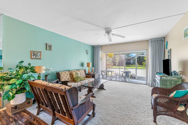 carpeted living room with ceiling fan