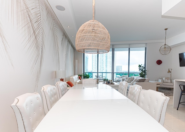 dining room featuring a wall of windows and light tile patterned floors