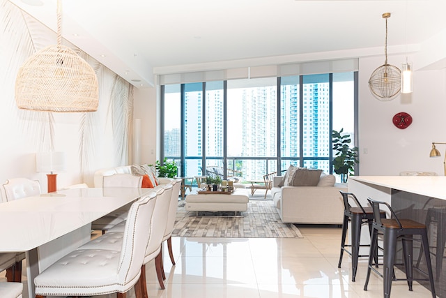 dining space with light tile patterned floors and floor to ceiling windows