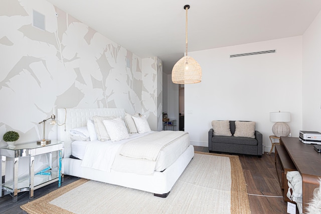 bedroom with wood finished floors, baseboards, and wallpapered walls