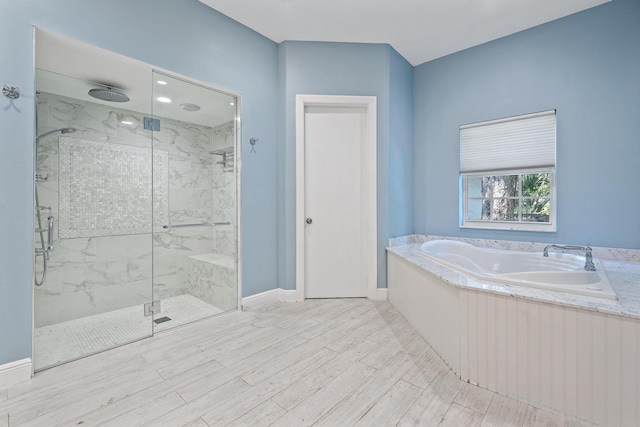 bathroom featuring hardwood / wood-style floors and independent shower and bath