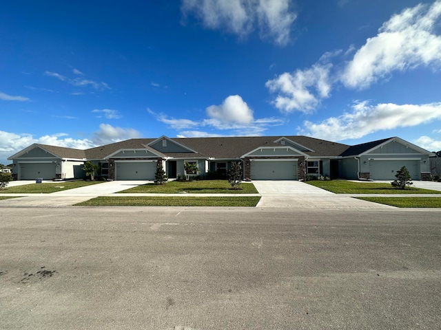 ranch-style home with a garage and a front lawn