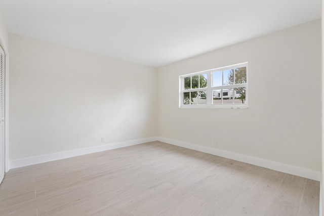 spare room with light wood-type flooring