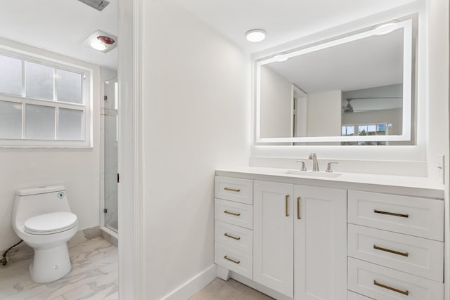 bathroom featuring a shower with door, vanity, and toilet