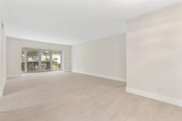 unfurnished room with light wood-type flooring