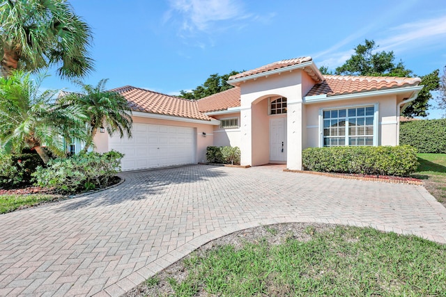 mediterranean / spanish-style house featuring a garage