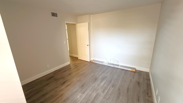 spare room with dark wood-type flooring