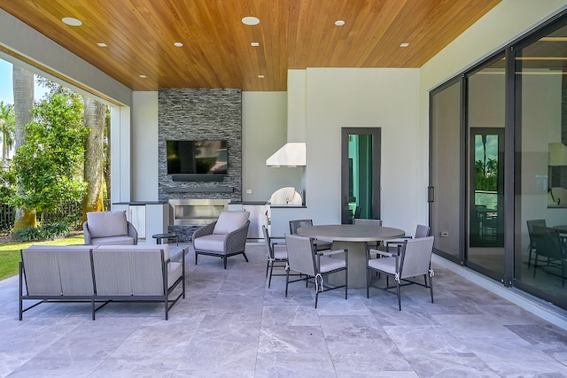 view of patio featuring an outdoor living space with a fireplace