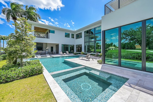 view of swimming pool featuring a patio area and an in ground hot tub