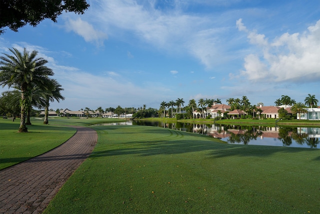 view of home's community featuring a lawn and a water view