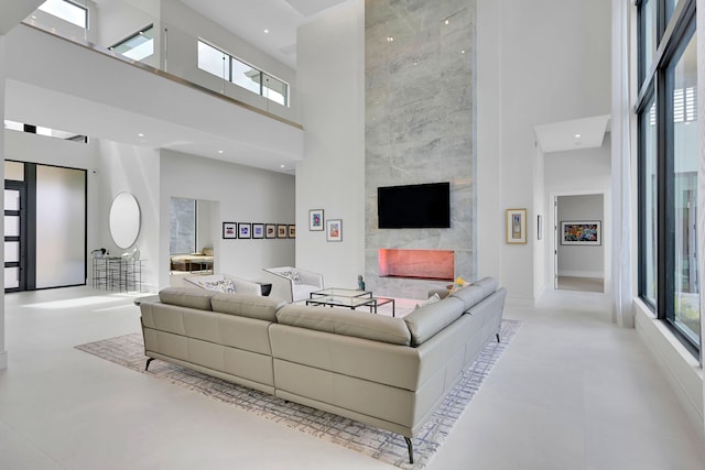 tiled living room featuring a towering ceiling