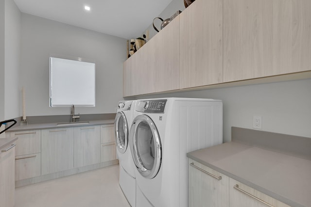 laundry room with sink, cabinets, and separate washer and dryer