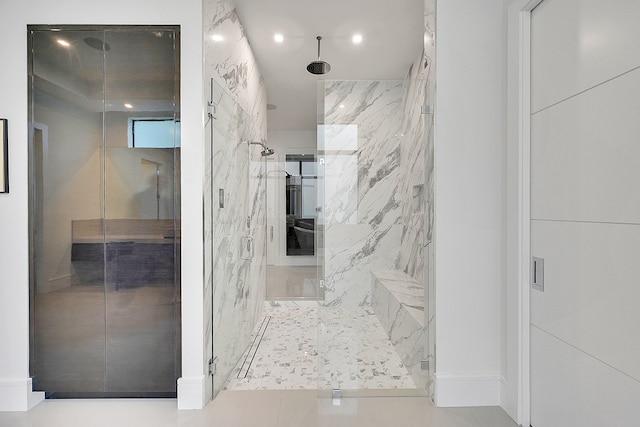 bathroom with walk in shower and tile floors