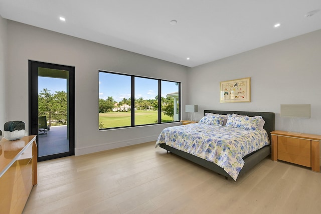 bedroom with access to outside and light wood-type flooring