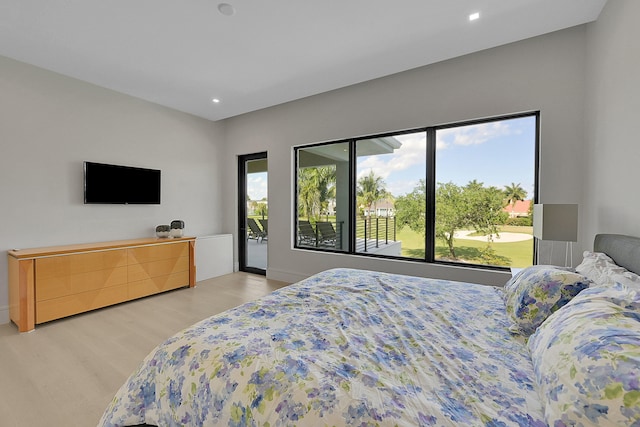 bedroom with multiple windows and light wood-type flooring