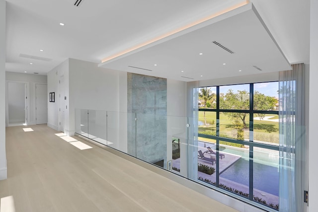 corridor with light hardwood / wood-style flooring