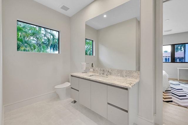 bathroom with large vanity, tile floors, and toilet