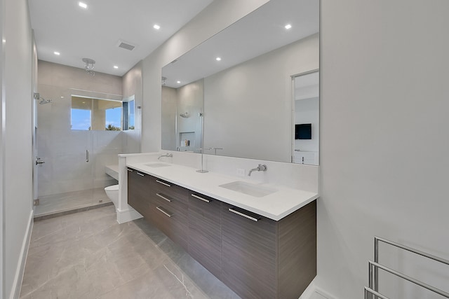 bathroom with an enclosed shower, toilet, tile floors, and dual bowl vanity