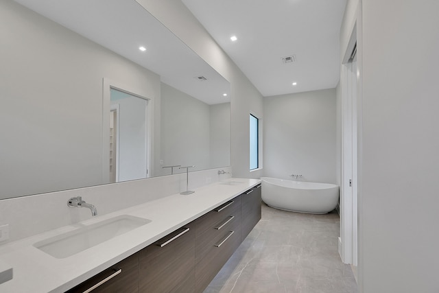 bathroom featuring a bath to relax in, tile floors, and double vanity