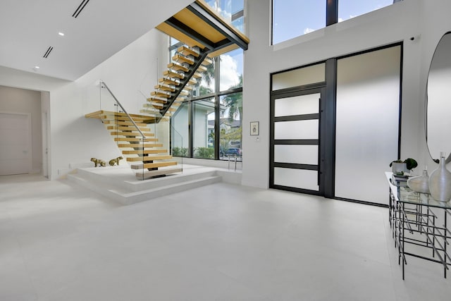 foyer entrance with a healthy amount of sunlight and a towering ceiling