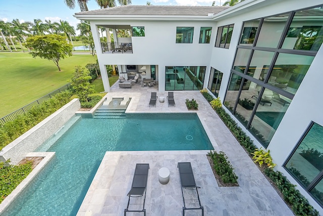 view of pool with a lawn and a patio