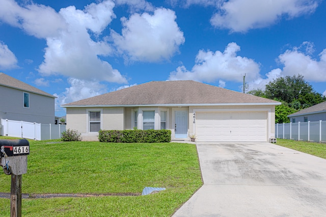 ranch-style home featuring a garage and a front lawn