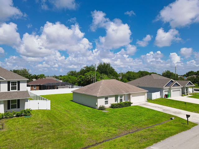 view of front of property featuring a garage and a front lawn