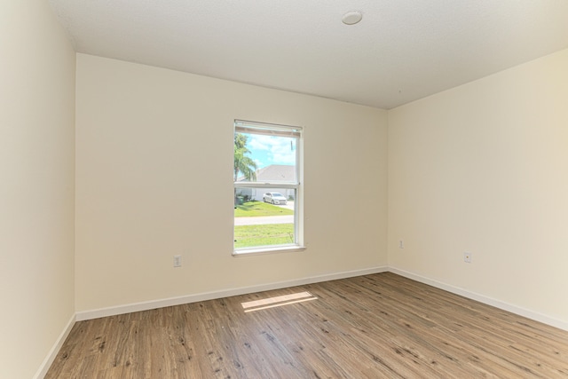 kitchen with decorative backsplash, stainless steel appliances, lofted ceiling, and hardwood / wood-style floors