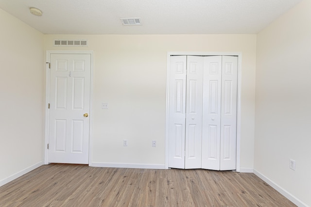 unfurnished bedroom with light wood-type flooring