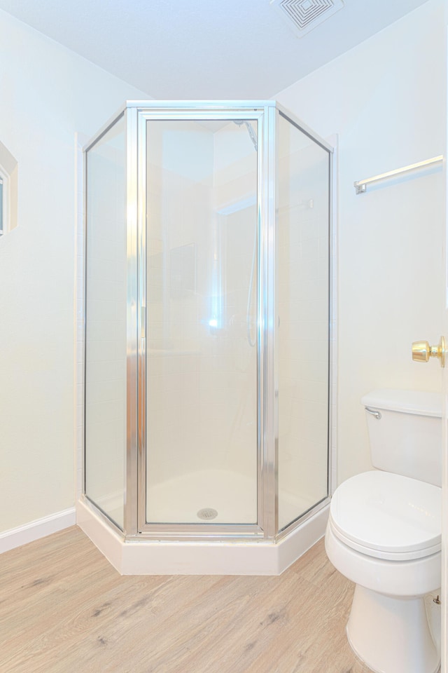 bathroom featuring a shower with shower door, hardwood / wood-style floors, and vanity