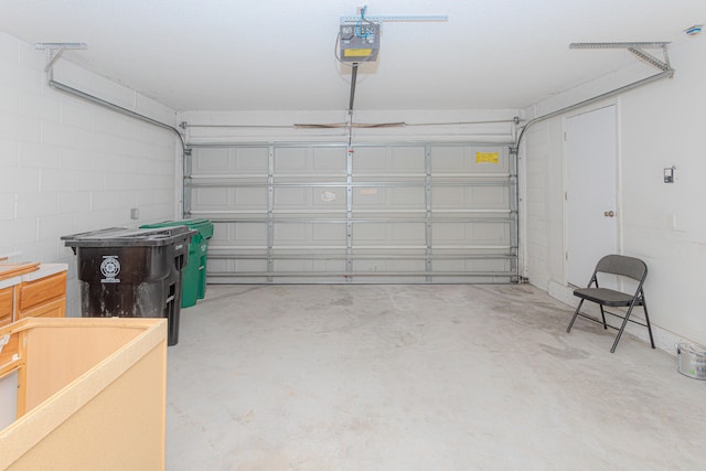 garage featuring heating unit, water heater, a garage door opener, and electric panel