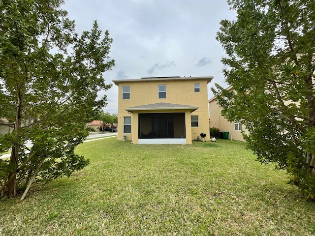 back of house with a lawn