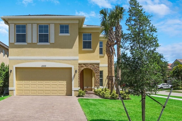 view of front of house with a front yard and a garage