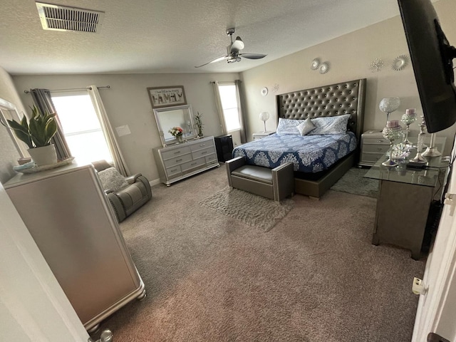 carpeted bedroom with a textured ceiling and ceiling fan