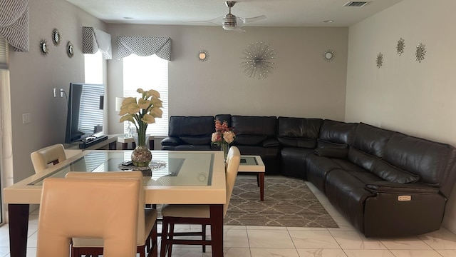 tiled living room with ceiling fan