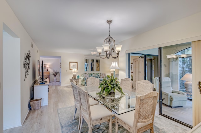 dining area featuring an inviting chandelier and light wood-type flooring