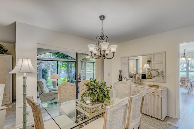 dining area featuring a notable chandelier, plenty of natural light, and light hardwood / wood-style floors