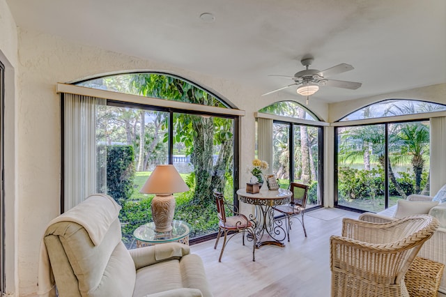 sunroom featuring ceiling fan