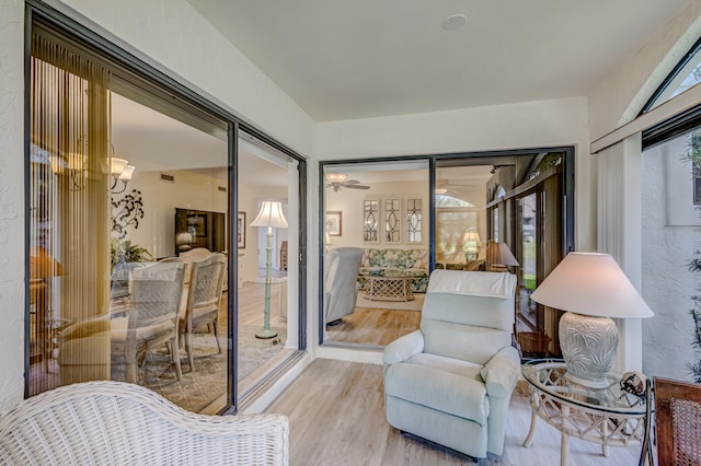 living area featuring ceiling fan and light hardwood / wood-style flooring